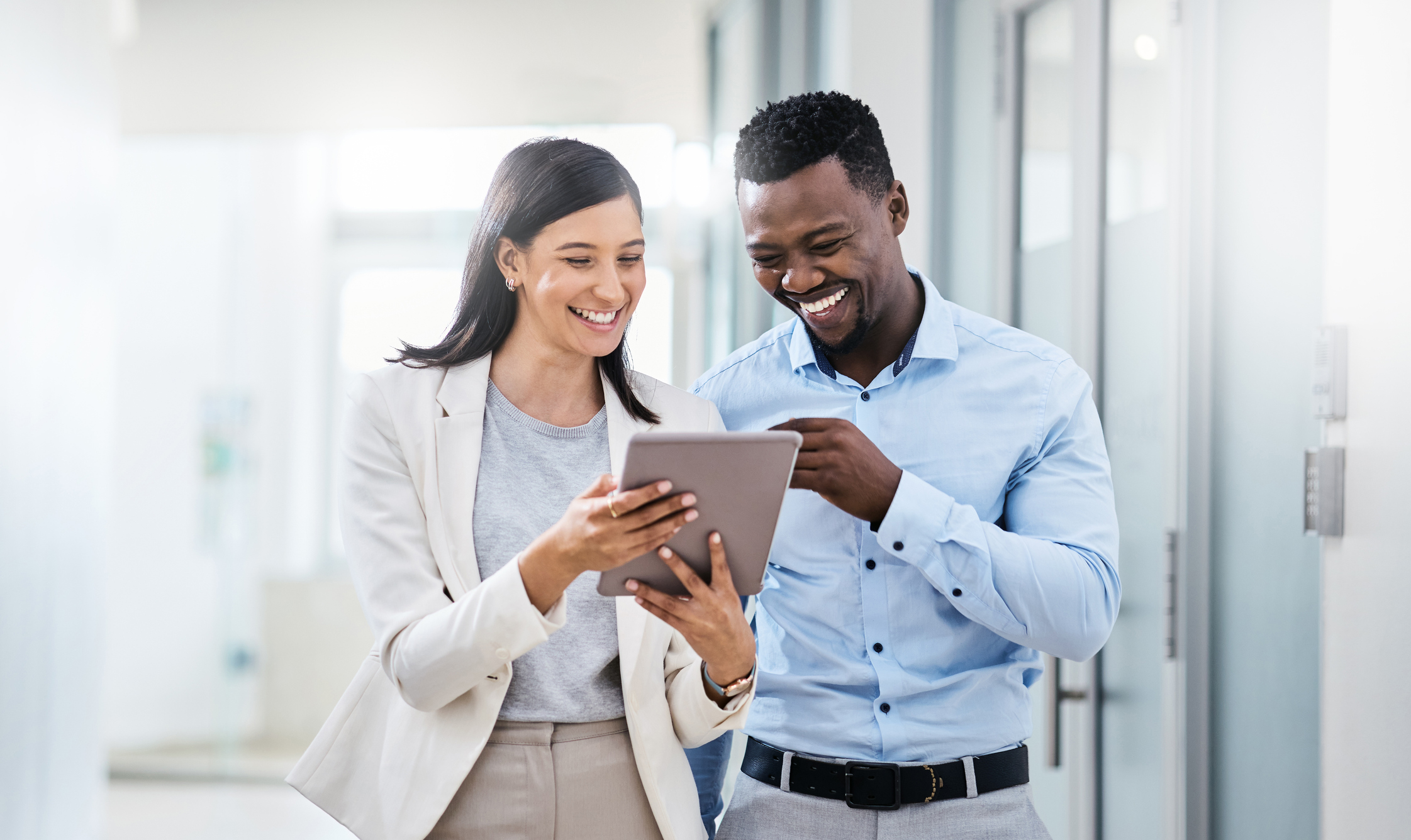 Shot of two businesspeople discussing something on a digital tablet